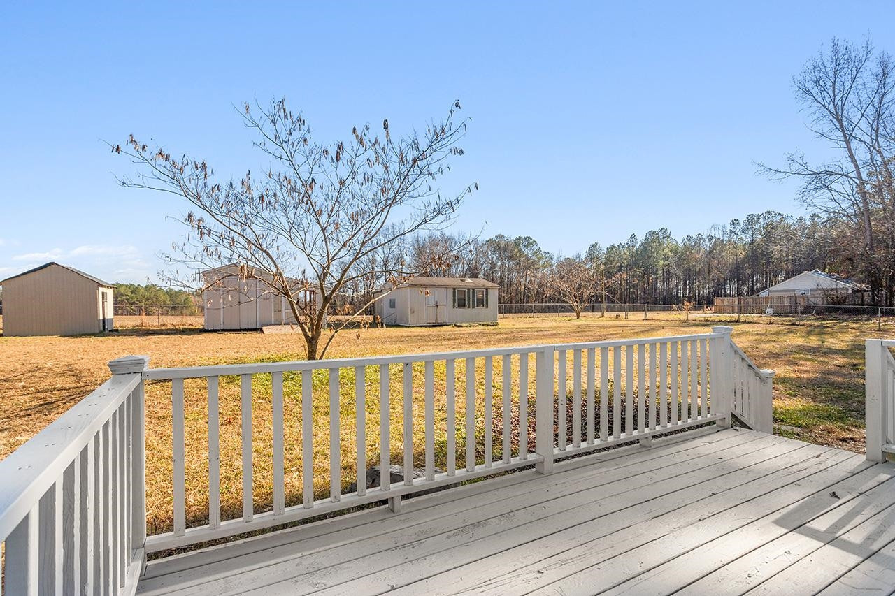 8401 South Creek Road Willow Spring, NC 27592 - Photo 22 of 24 a view of wooden deck and a lake view