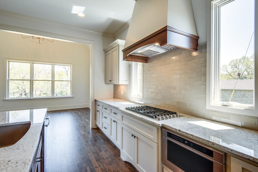 5622 Valley View Road Brentwood, TN 37027 - Photo 11 of 28 a kitchen with stainless steel appliances granite countertop a stove a sink and a window