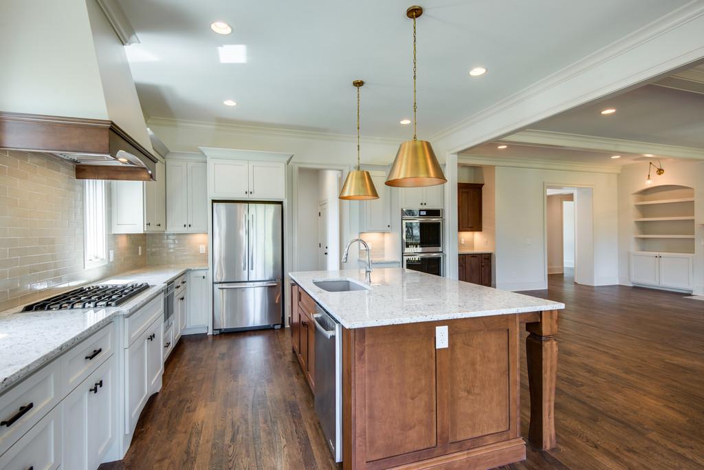 5622 Valley View Road Brentwood, TN 37027 - Photo 13 of 28 a kitchen with stainless steel appliances kitchen island granite countertop a stove a sink a refrigerator and a oven with wooden floor