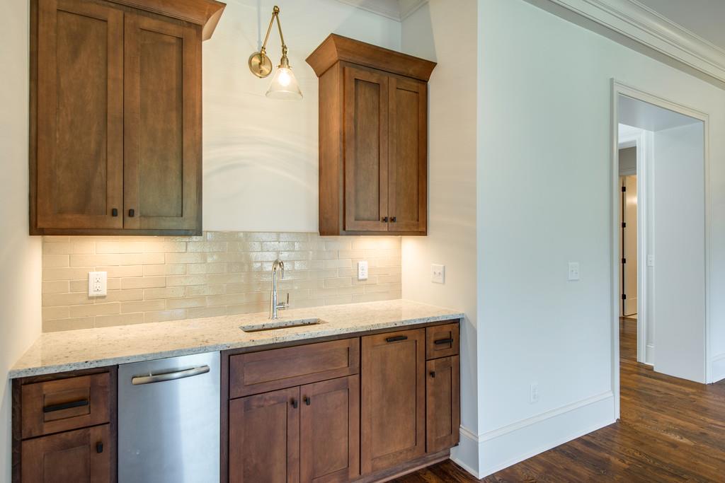 5622 Valley View Road Brentwood, TN 37027 - Photo 8 of 28 a sink with granite countertop wooden cabinets