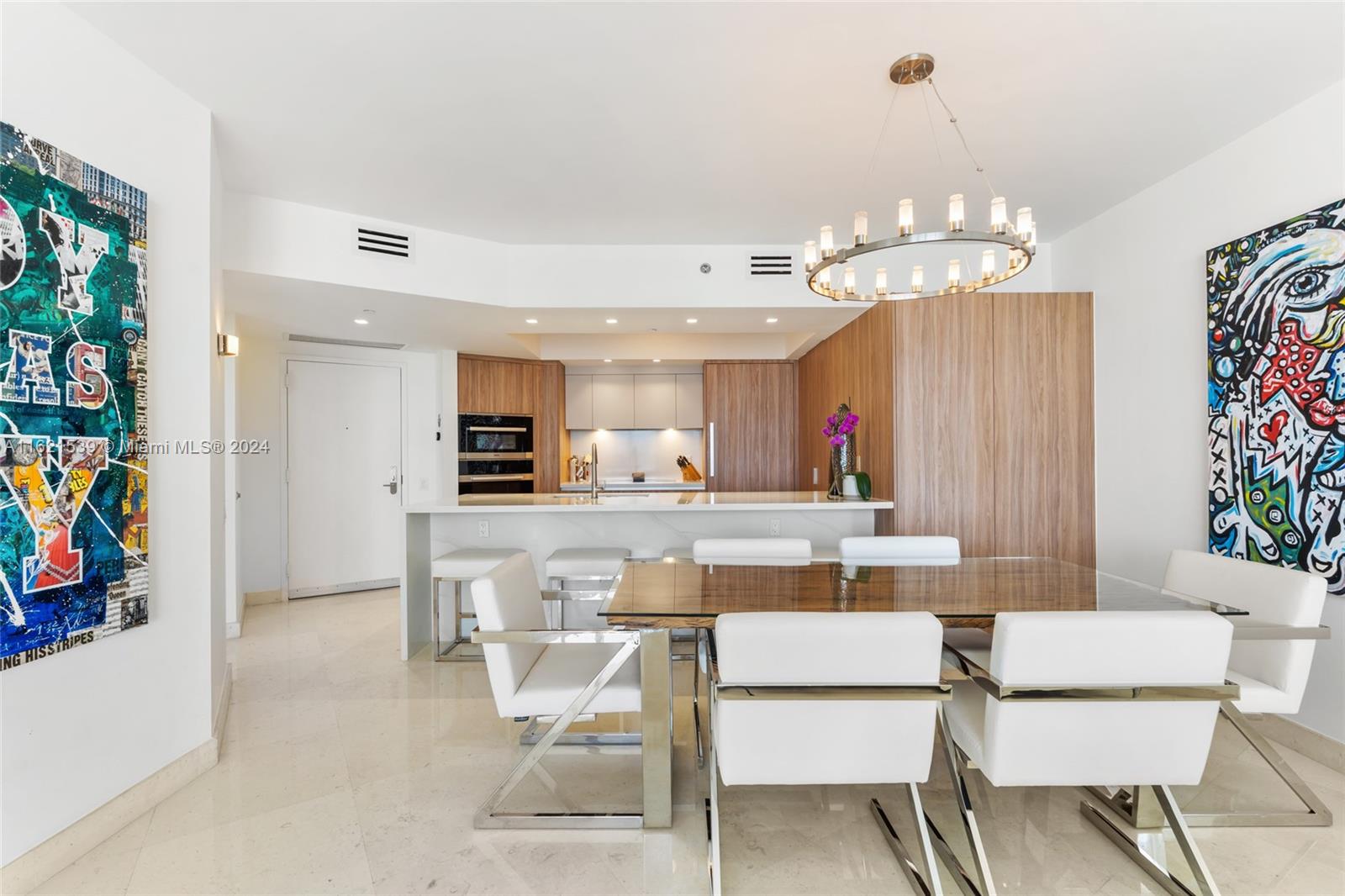 450 Alton Road, Unit 3106 Miami Beach, FL 33139 - Photo 11 of 40 a view of a dining room with furniture and chandelier