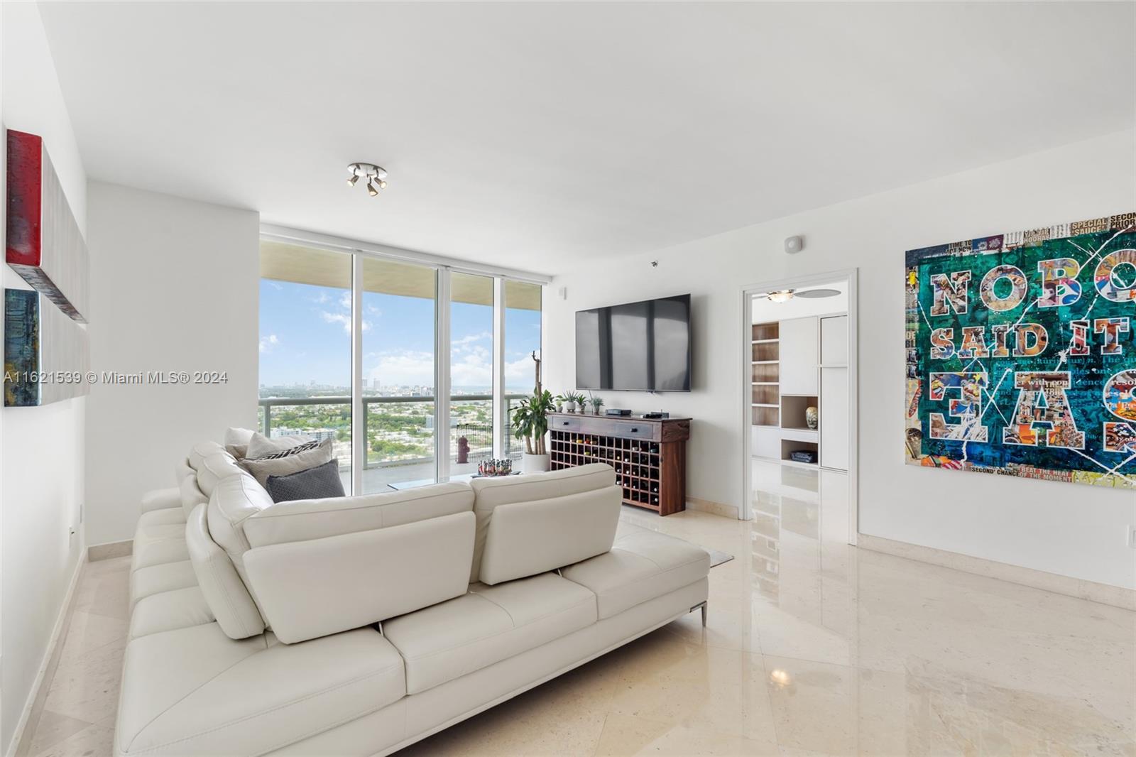 450 Alton Road, Unit 3106 Miami Beach, FL 33139 - Photo 12 of 40 a living room with furniture fireplace and flat screen tv