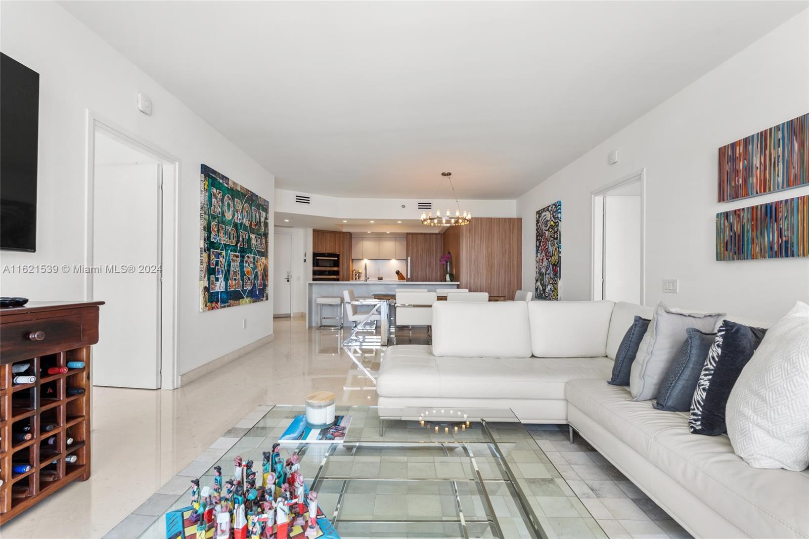 450 Alton Road, Unit 3106 Miami Beach, FL 33139 - Photo 15 of 40 a living room with furniture and a book shelf