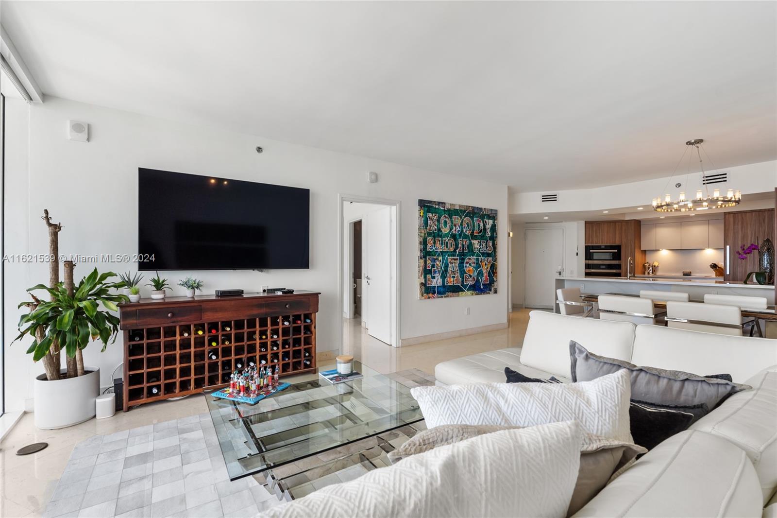 450 Alton Road, Unit 3106 Miami Beach, FL 33139 - Photo 16 of 40 a living room with furniture and a flat screen tv