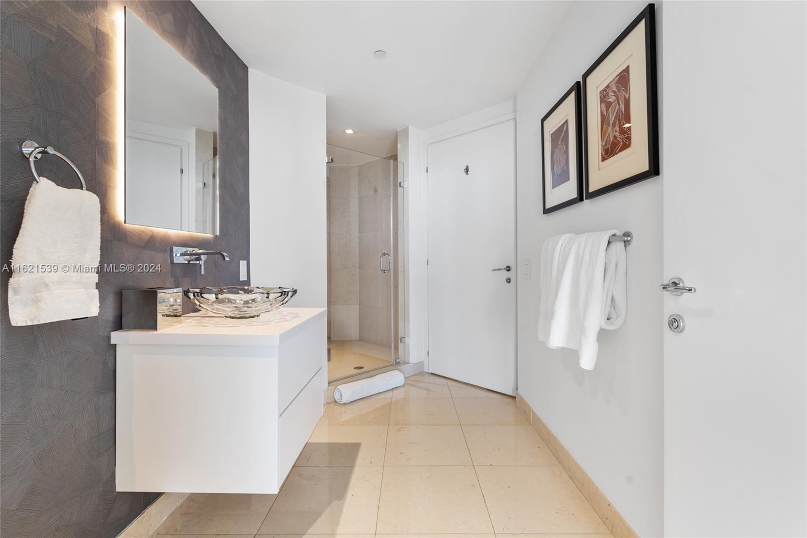 450 Alton Road, Unit 3106 Miami Beach, FL 33139 - Photo 19 of 40 a bathroom with a sink and mirror