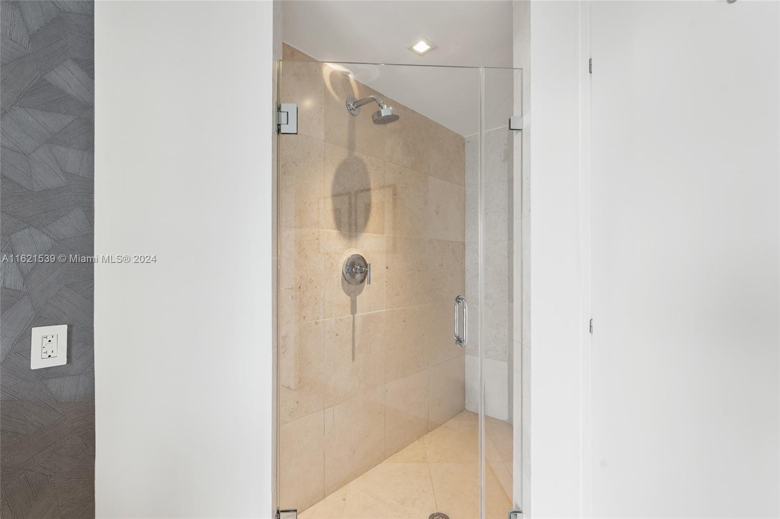 450 Alton Road, Unit 3106 Miami Beach, FL 33139 - Photo 20 of 40 a bathroom with a shower and a glass door