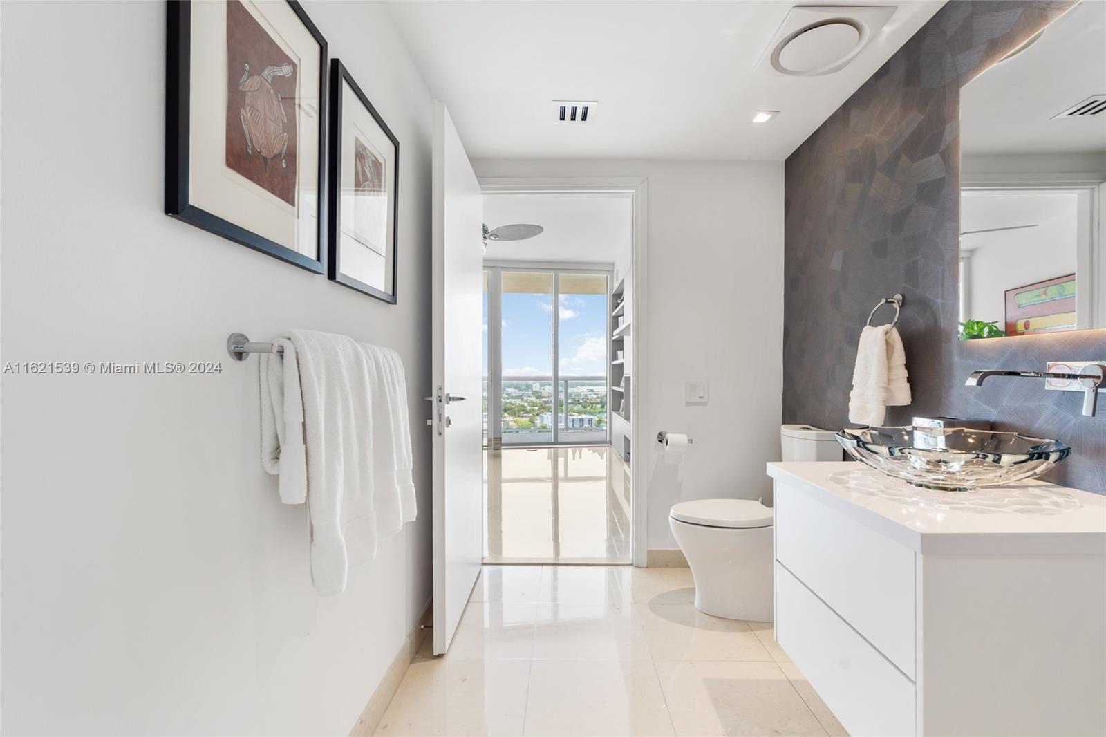 450 Alton Road, Unit 3106 Miami Beach, FL 33139 - Photo 21 of 40 a bathroom with a sink toilet and shower