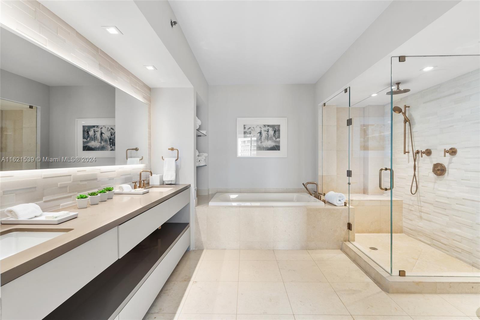 450 Alton Road, Unit 3106 Miami Beach, FL 33139 - Photo 24 of 40 a spacious bathroom with a granite countertop tub sink and mirror