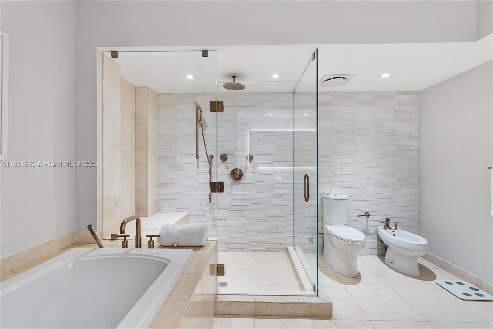 450 Alton Road, Unit 3106 Miami Beach, FL 33139 - Photo 27 of 40 a bathroom with a sink a toilet and shower