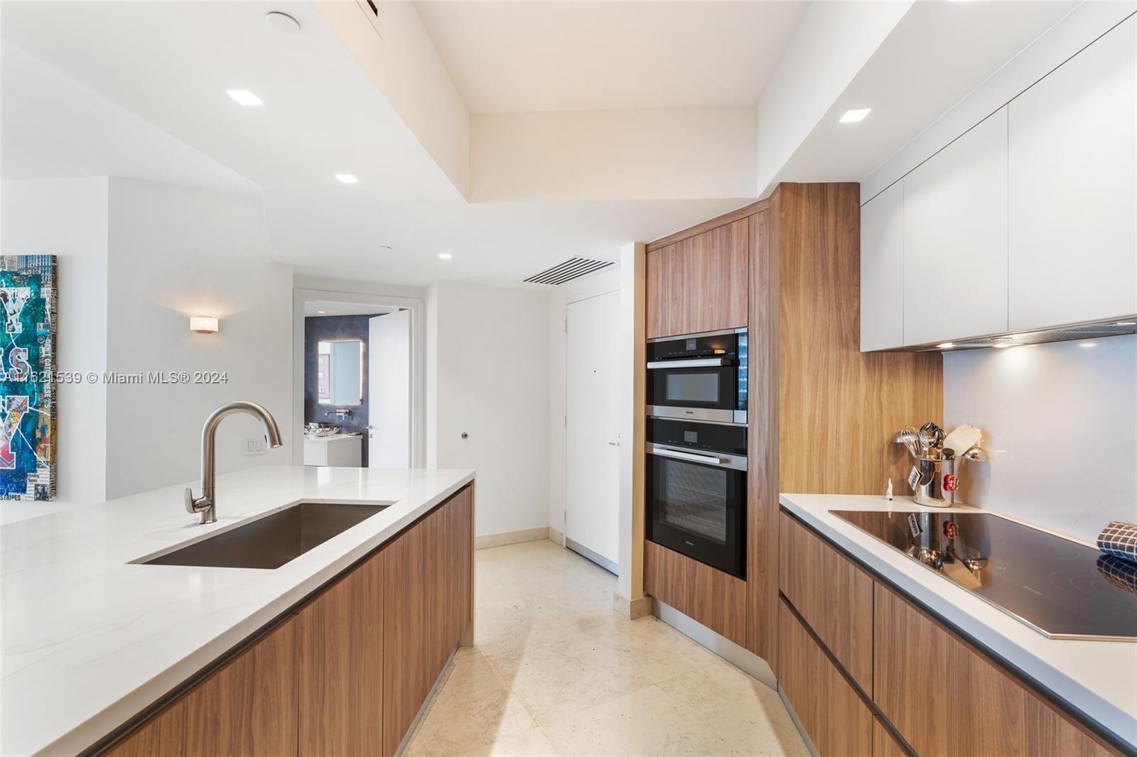 450 Alton Road, Unit 3106 Miami Beach, FL 33139 - Photo 4 of 40 a kitchen with counter top space cabinets and stainless steel appliances