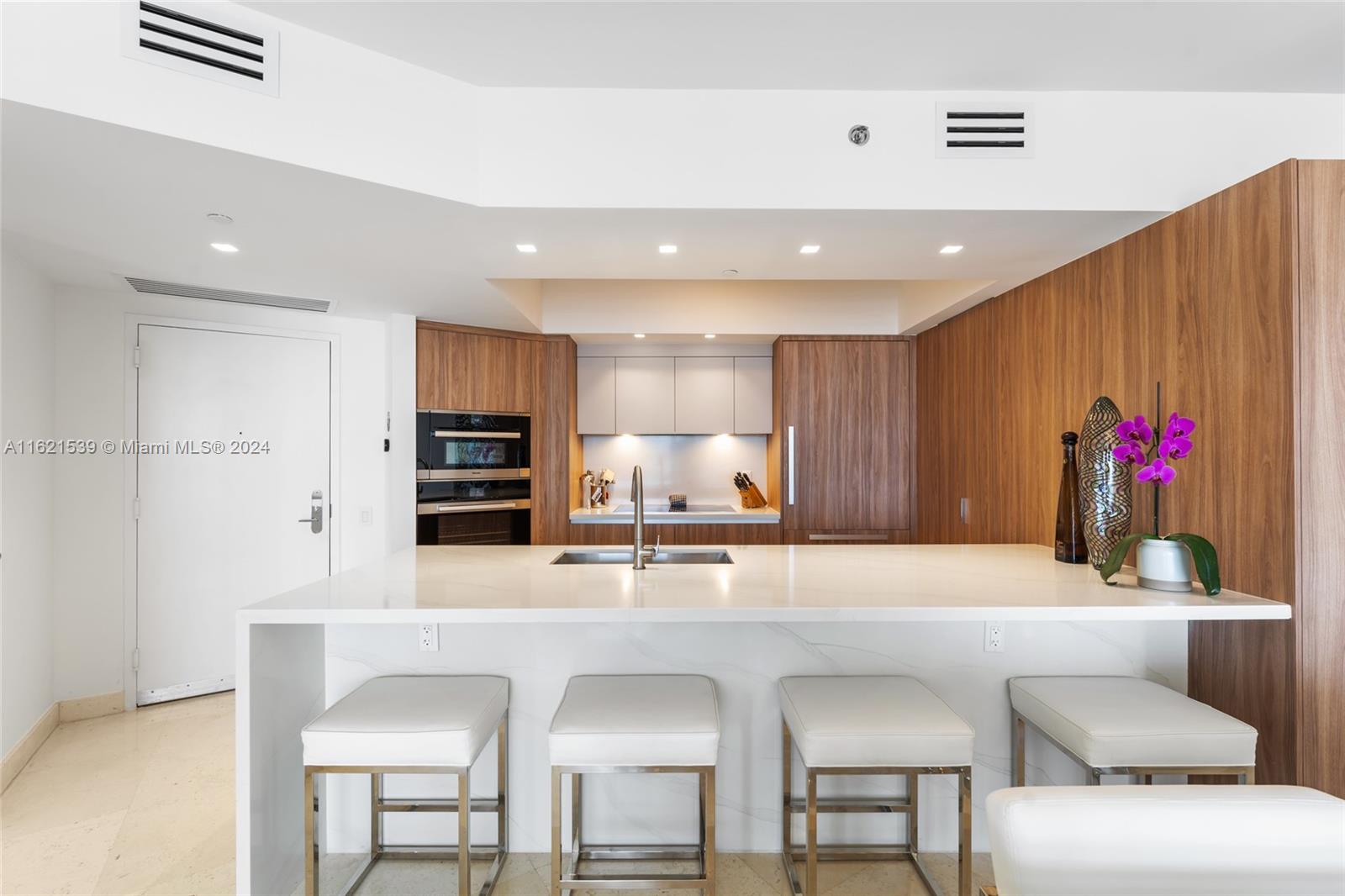 450 Alton Road, Unit 3106 Miami Beach, FL 33139 - Photo 6 of 40 a kitchen with stainless steel appliances kitchen island granite countertop a stove a sink and a refrigerator