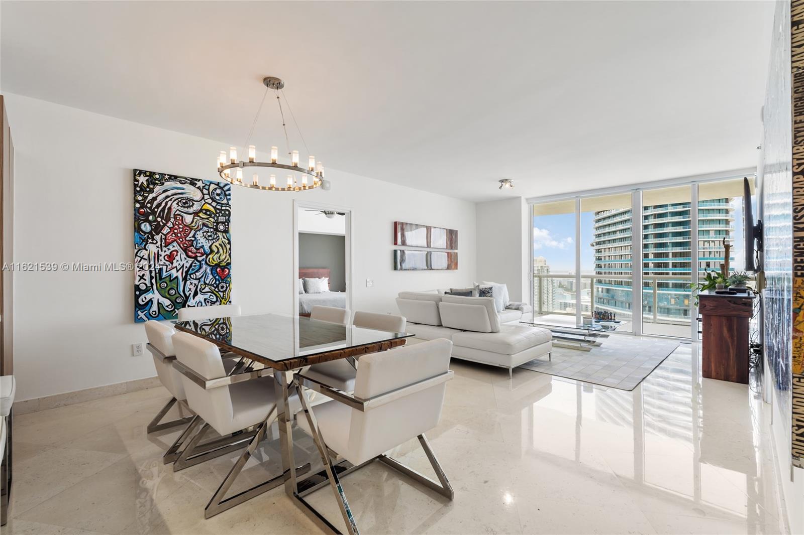 450 Alton Road, Unit 3106 Miami Beach, FL 33139 - Photo 7 of 40 a living room with furniture and a chandelier
