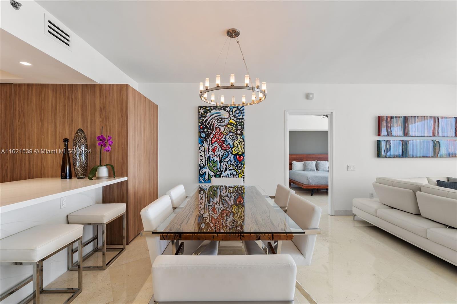 450 Alton Road, Unit 3106 Miami Beach, FL 33139 - Photo 8 of 40 a living room with furniture and a chandelier