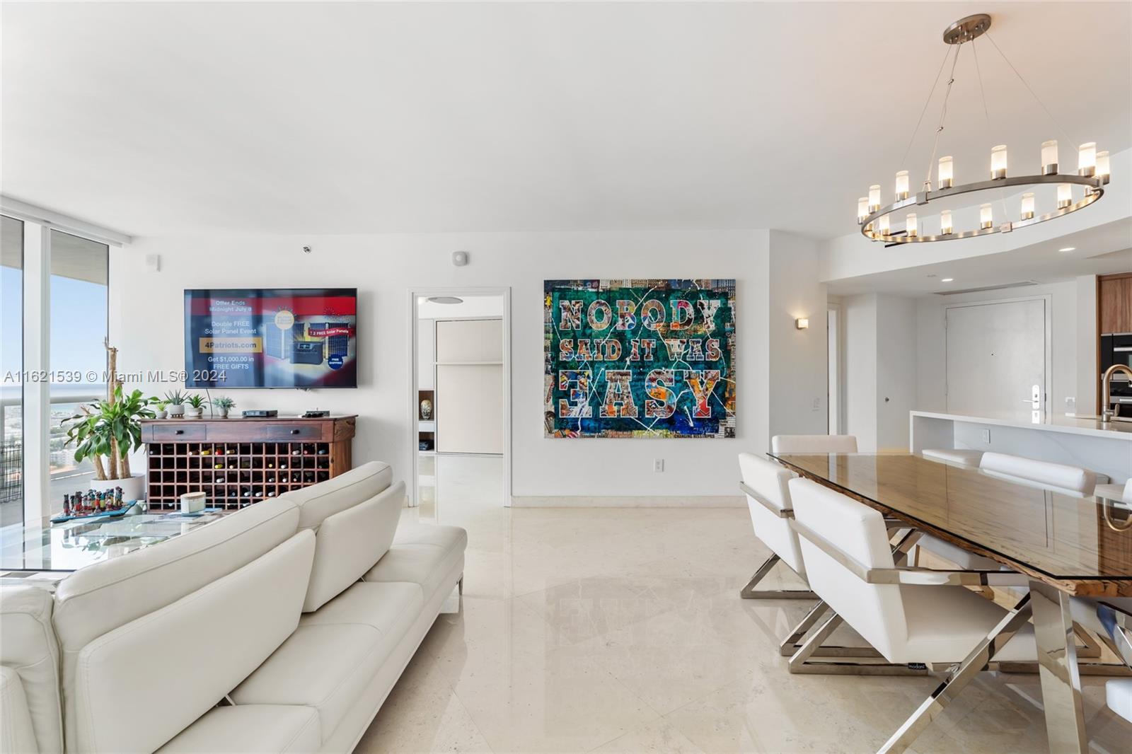 450 Alton Road, Unit 3106 Miami Beach, FL 33139 - Photo 10 of 40 a view of a living room and chandelier