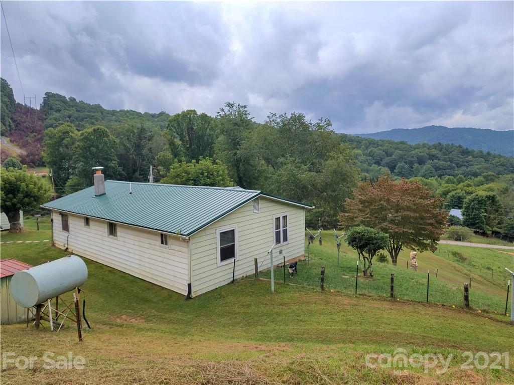 1731 Chambers Mountain Road Clyde, NC 28721 - Photo 2 of 37 a aerial view of a house with a yard table and chairs