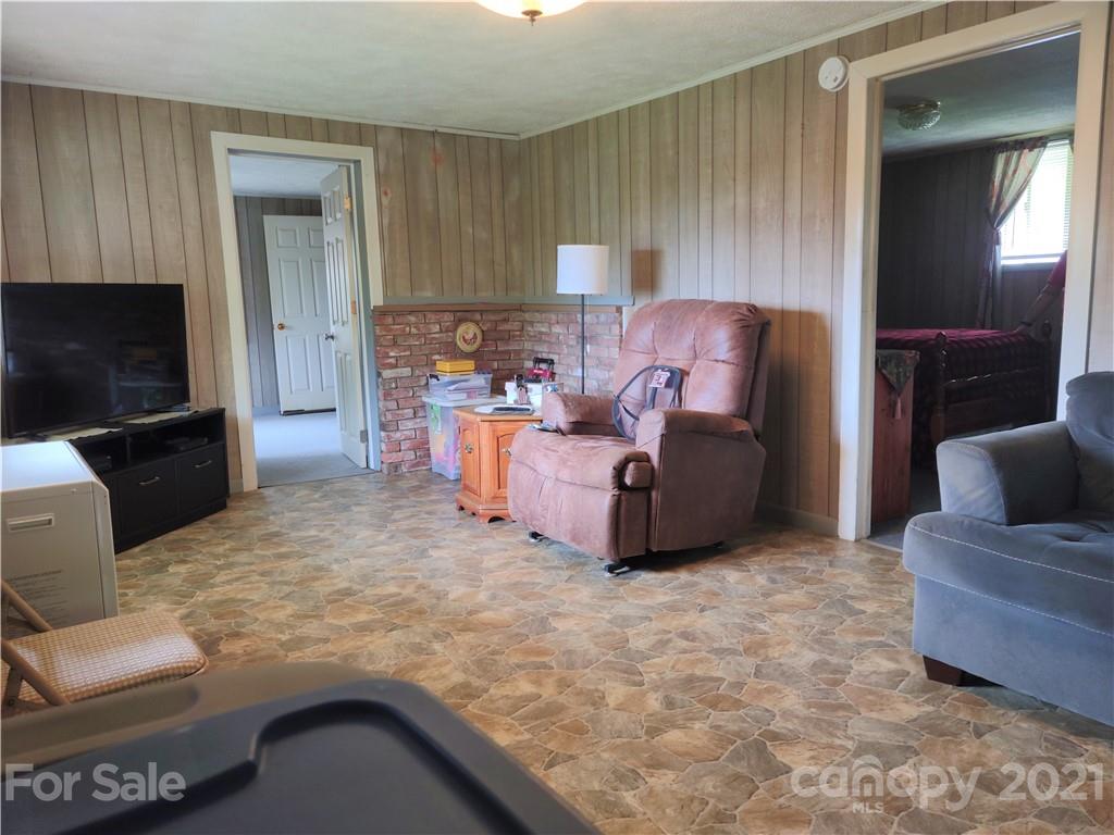 1731 Chambers Mountain Road Clyde, NC 28721 - Photo 11 of 37 a living room with furniture and a flat screen tv