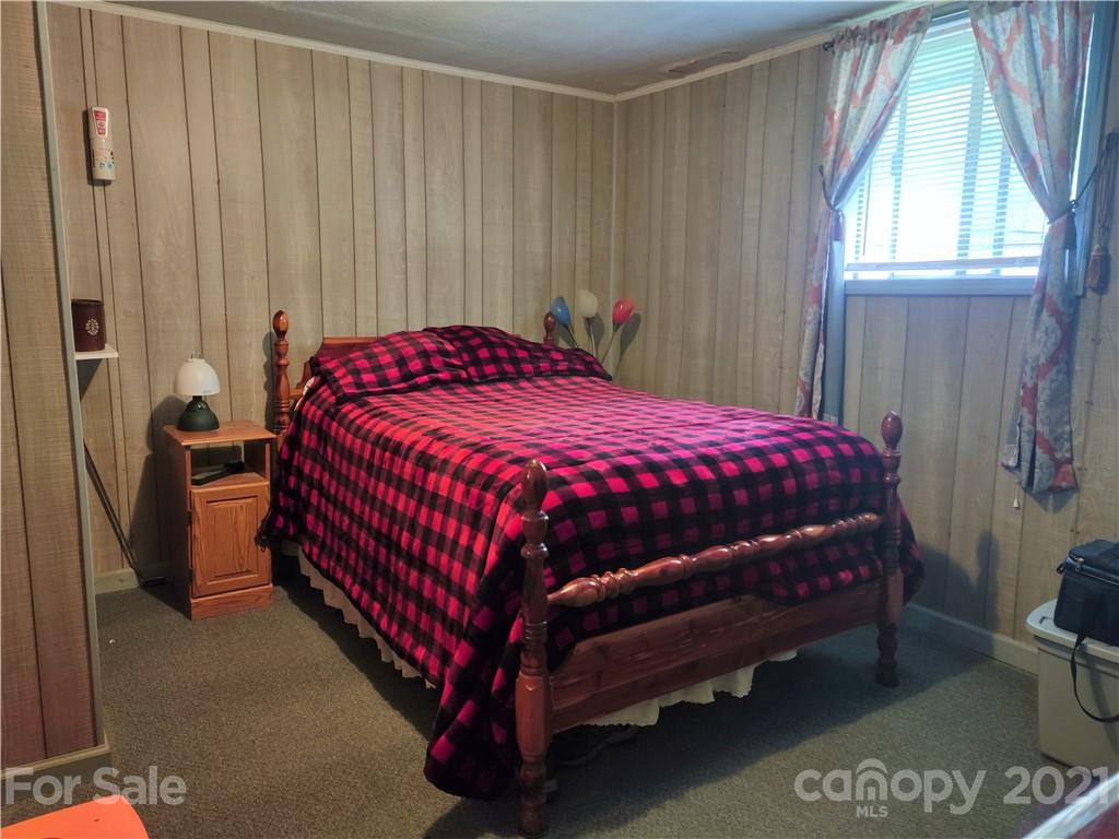 1731 Chambers Mountain Road Clyde, NC 28721 - Photo 13 of 37 a bedroom with a bed and a window