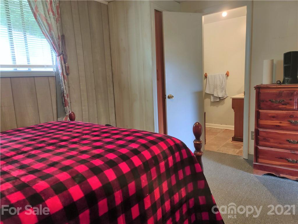 1731 Chambers Mountain Road Clyde, NC 28721 - Photo 14 of 37 a bedroom with a bed and a dresser