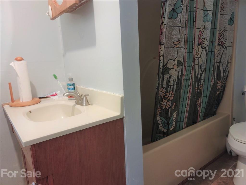 1731 Chambers Mountain Road Clyde, NC 28721 - Photo 15 of 37 a bathroom with a sink a toilet and shower