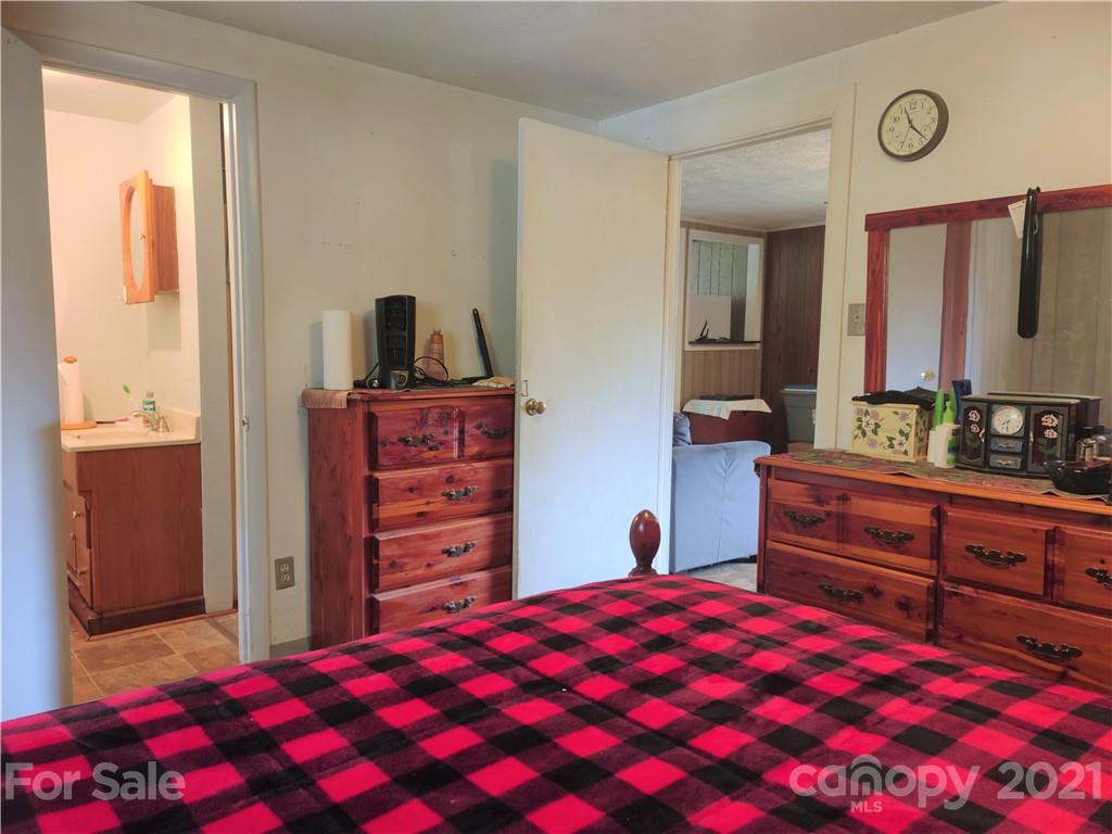 1731 Chambers Mountain Road Clyde, NC 28721 - Photo 16 of 37 a bedroom with a bed and a dresser