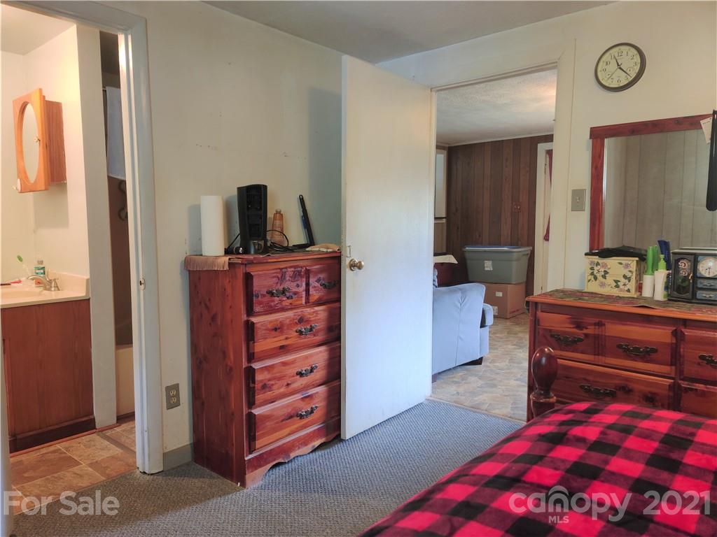 1731 Chambers Mountain Road Clyde, NC 28721 - Photo 17 of 37 a bedroom with a bed and a dresser