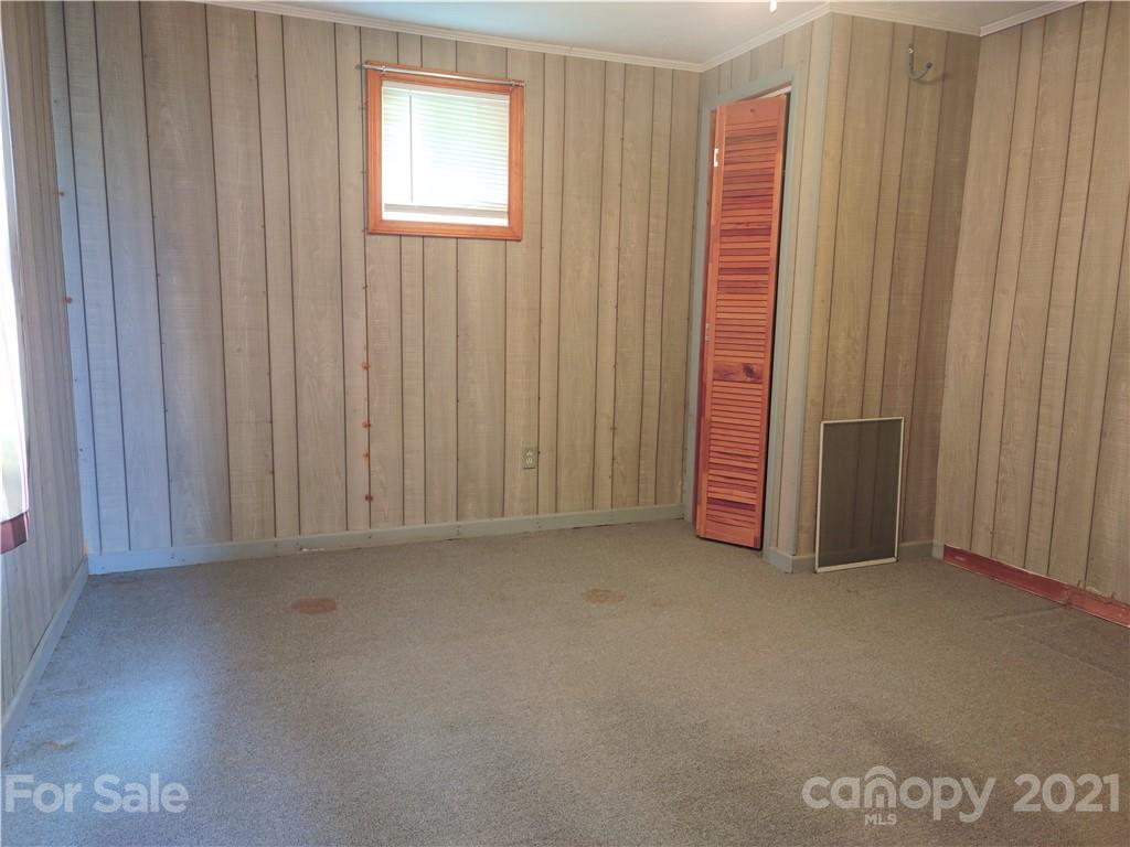 1731 Chambers Mountain Road Clyde, NC 28721 - Photo 21 of 37 a view of a room with an empty space and a window