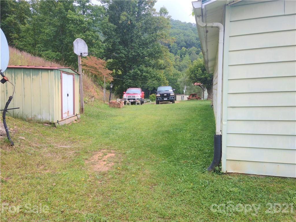 1731 Chambers Mountain Road Clyde, NC 28721 - Photo 30 of 37 a backyard of a house with lots of green space and fountain