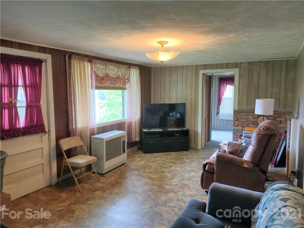 1731 Chambers Mountain Road Clyde, NC 28721 - Photo 6 of 37 a living room with furniture and a flat screen tv