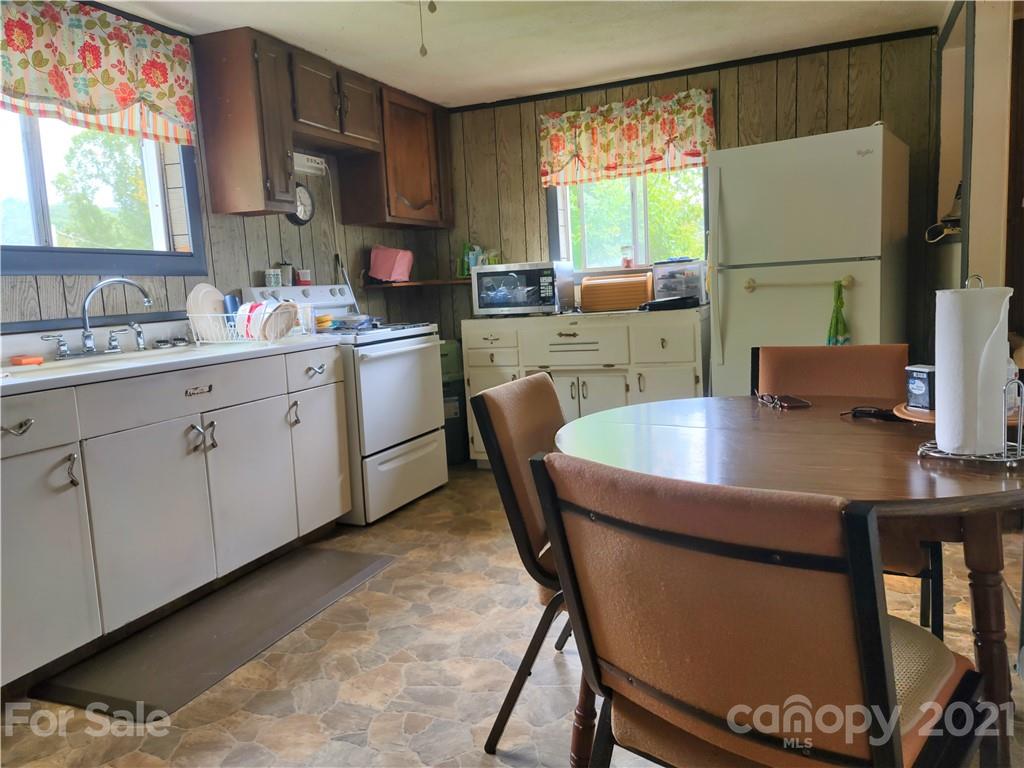 1731 Chambers Mountain Road Clyde, NC 28721 - Photo 8 of 37 a kitchen with a table chairs and a refrigerator