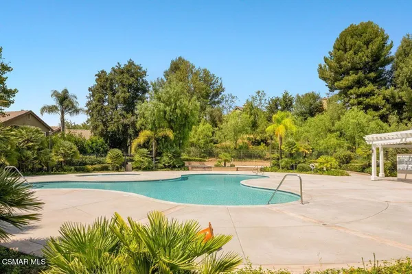 a view of a swimming pool and trees in the background