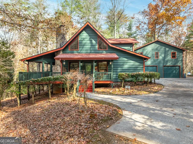 a view of a house with a patio and a yard