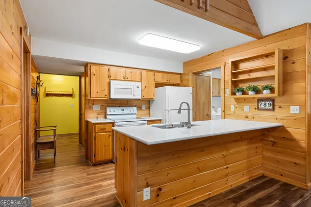 a kitchen with stainless steel appliances granite countertop a sink a stove and a refrigerator