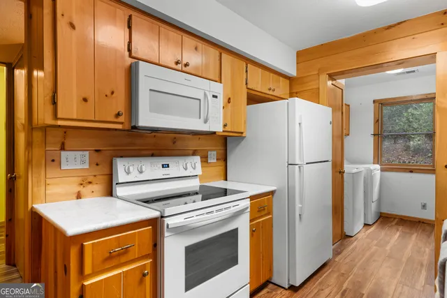 a kitchen with a sink a window and appliances