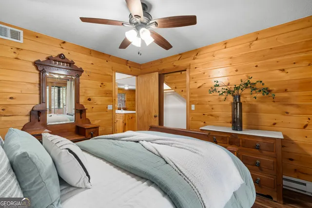 a view of a patio with table and chairs with wooden floor and fence