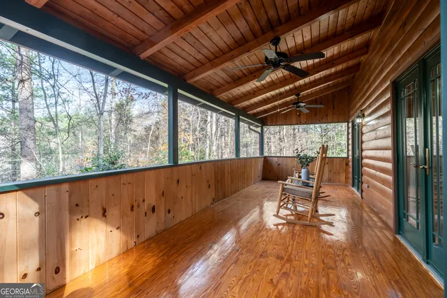 a view of a bathroom with wooden floor and a window