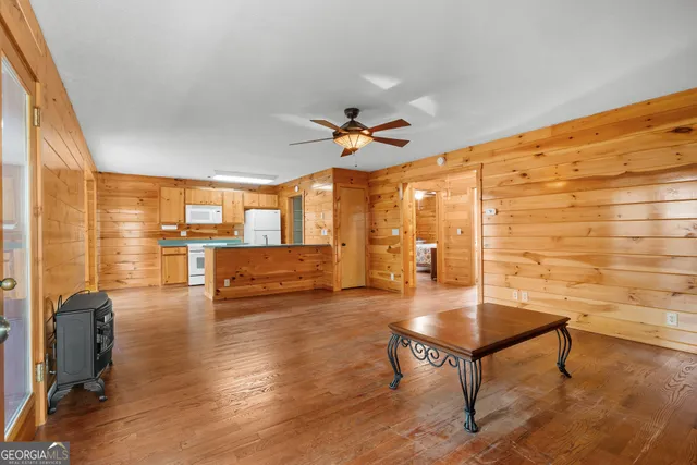 a view of a yard with plants and trees