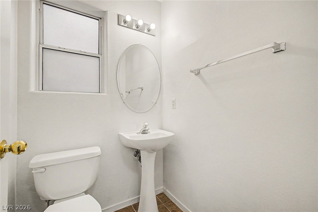 2223 Ramsgate Drive Henderson, NV 89074 - Photo 11 of 32 A well-lit powder room offers privacy and essential amenities for guests.