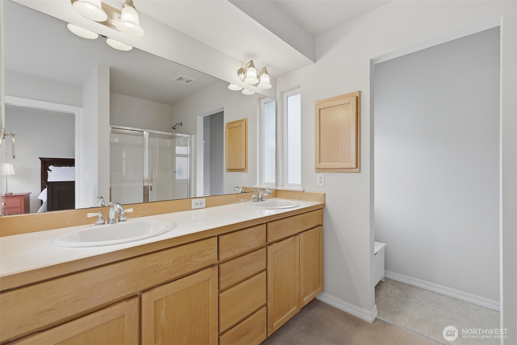 17747 89th Court Northeast Bothell, WA 98011 - Photo 20 of 33 a bathroom with a granite countertop sink a large mirror and a light fixture