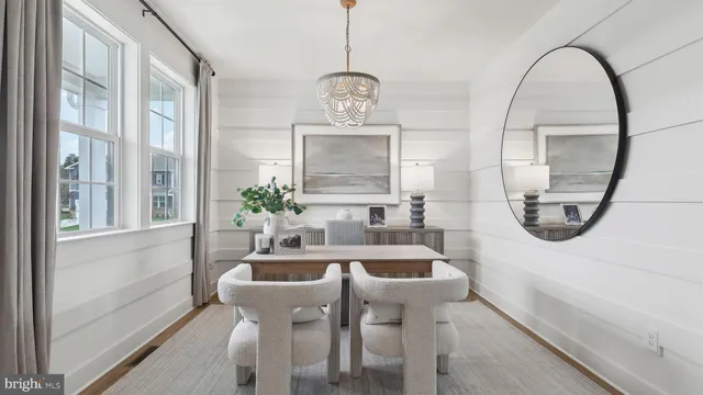 a dining room with furniture and a mirror