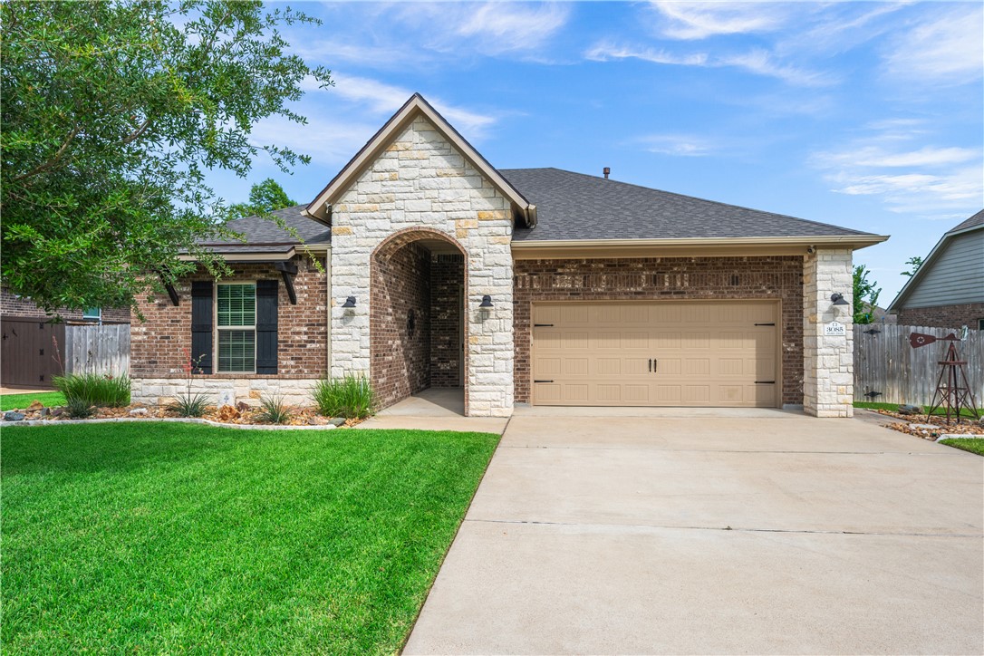 3085 Archer Circle Bryan, TX 77808 - Photo 1 of 31 a front view of a house with a yard and garage
