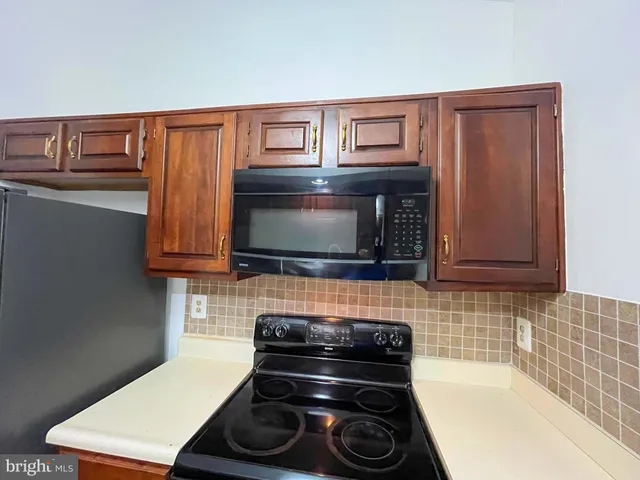 a stove top oven sitting inside of a kitchen