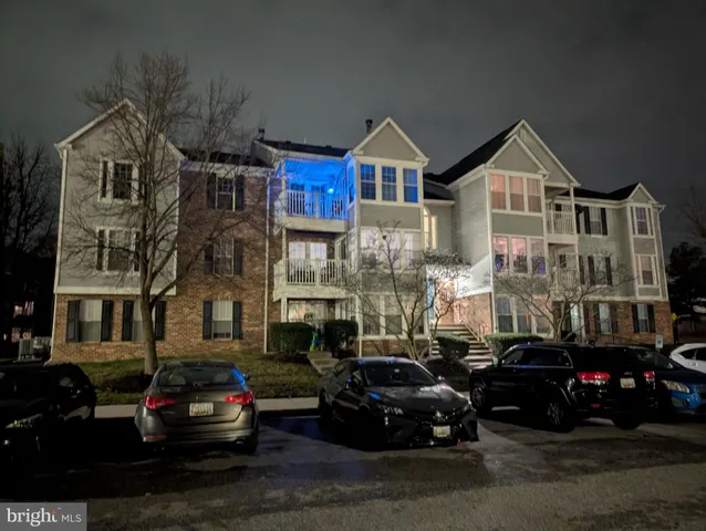 a car parked in front of a brick house