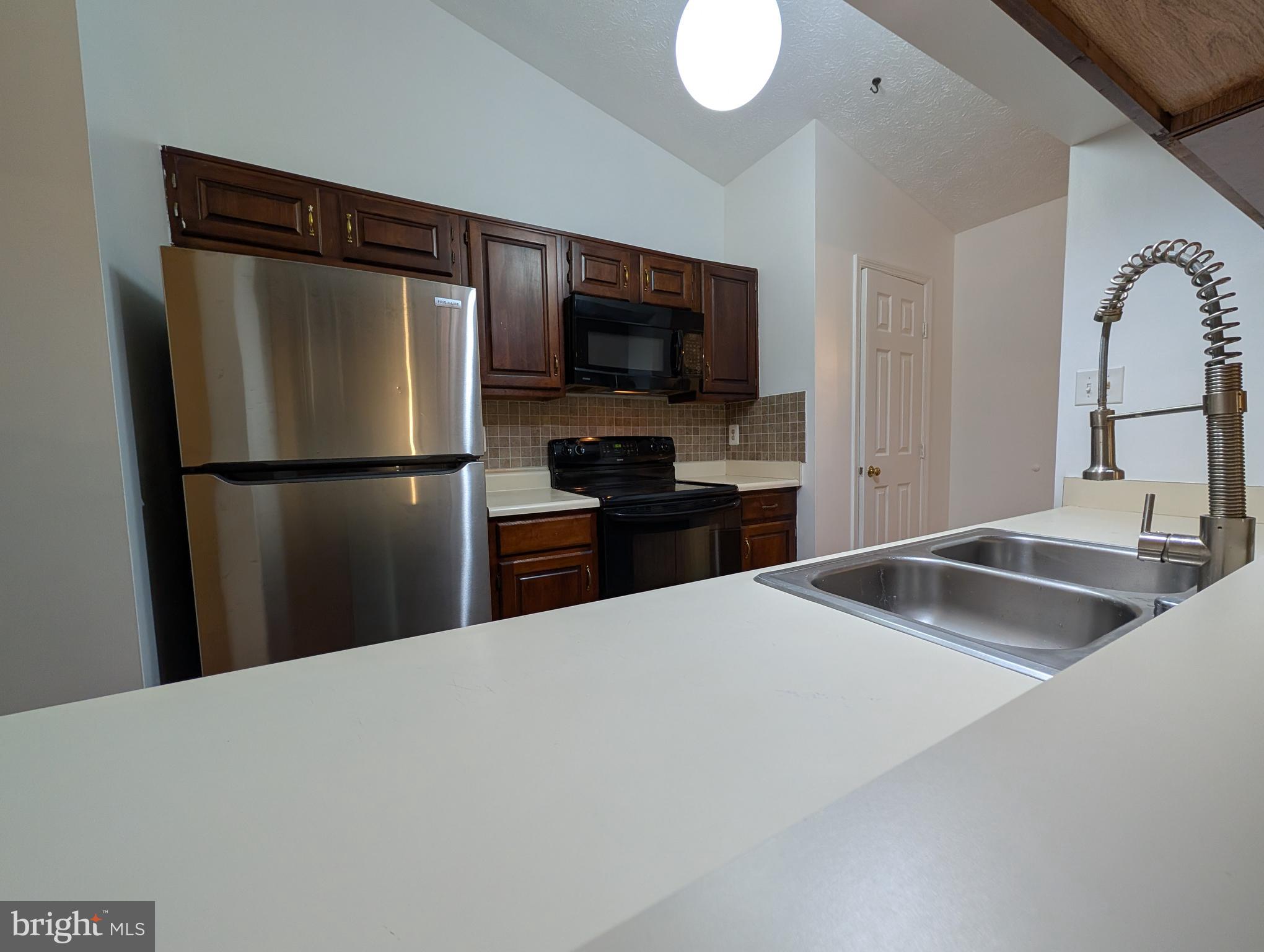 1301 L Cedar Crest Court, Unit 1301L Edgewood, MD 21040 - Photo 32 of 43 a kitchen with a refrigerator and a sink