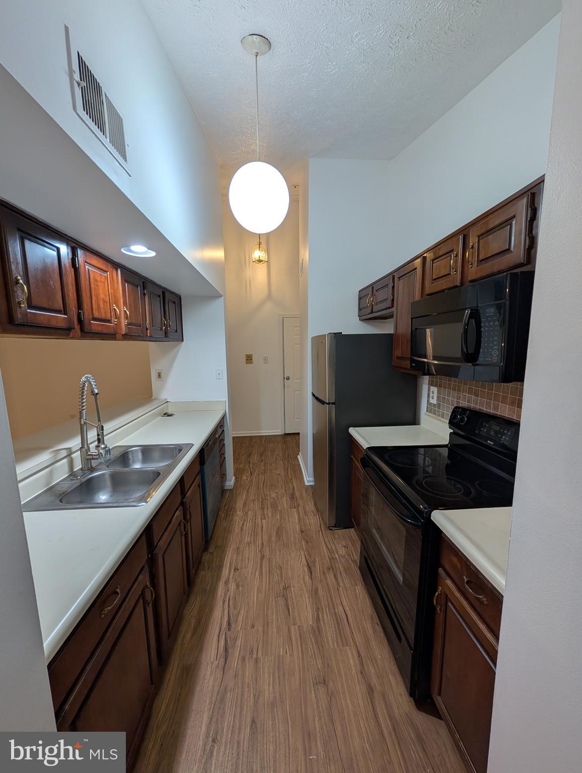 1301 L Cedar Crest Court, Unit 1301L Edgewood, MD 21040 - Photo 33 of 43 a kitchen with stainless steel appliances a sink stove and cabinets