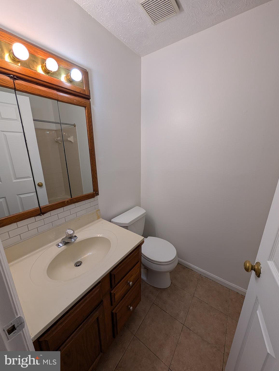 1301 L Cedar Crest Court, Unit 1301L Edgewood, MD 21040 - Photo 39 of 43 a bathroom with a sink a toilet and mirror