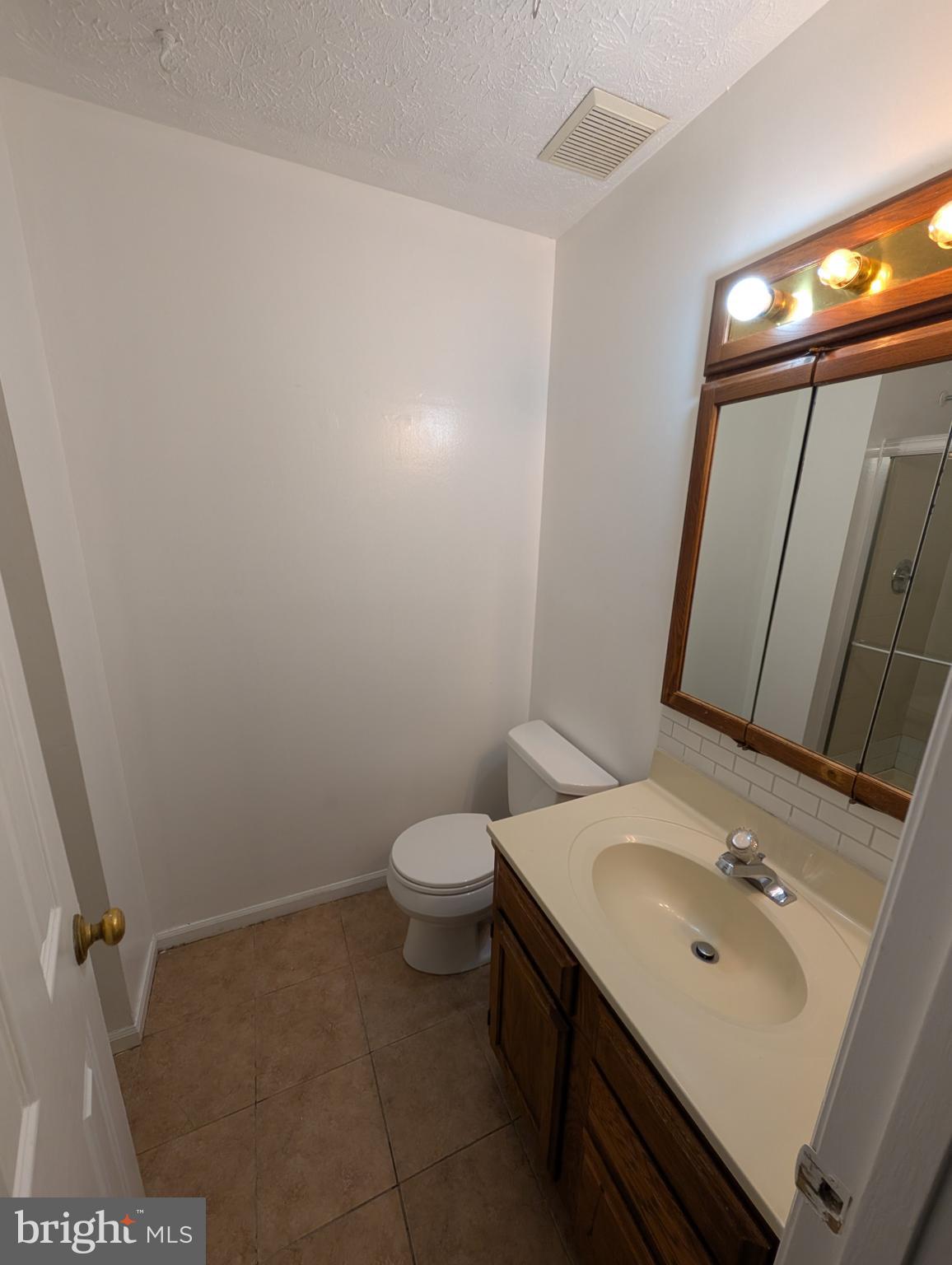 1301 L Cedar Crest Court, Unit 1301L Edgewood, MD 21040 - Photo 41 of 43 a bathroom with a sink a toilet and mirror
