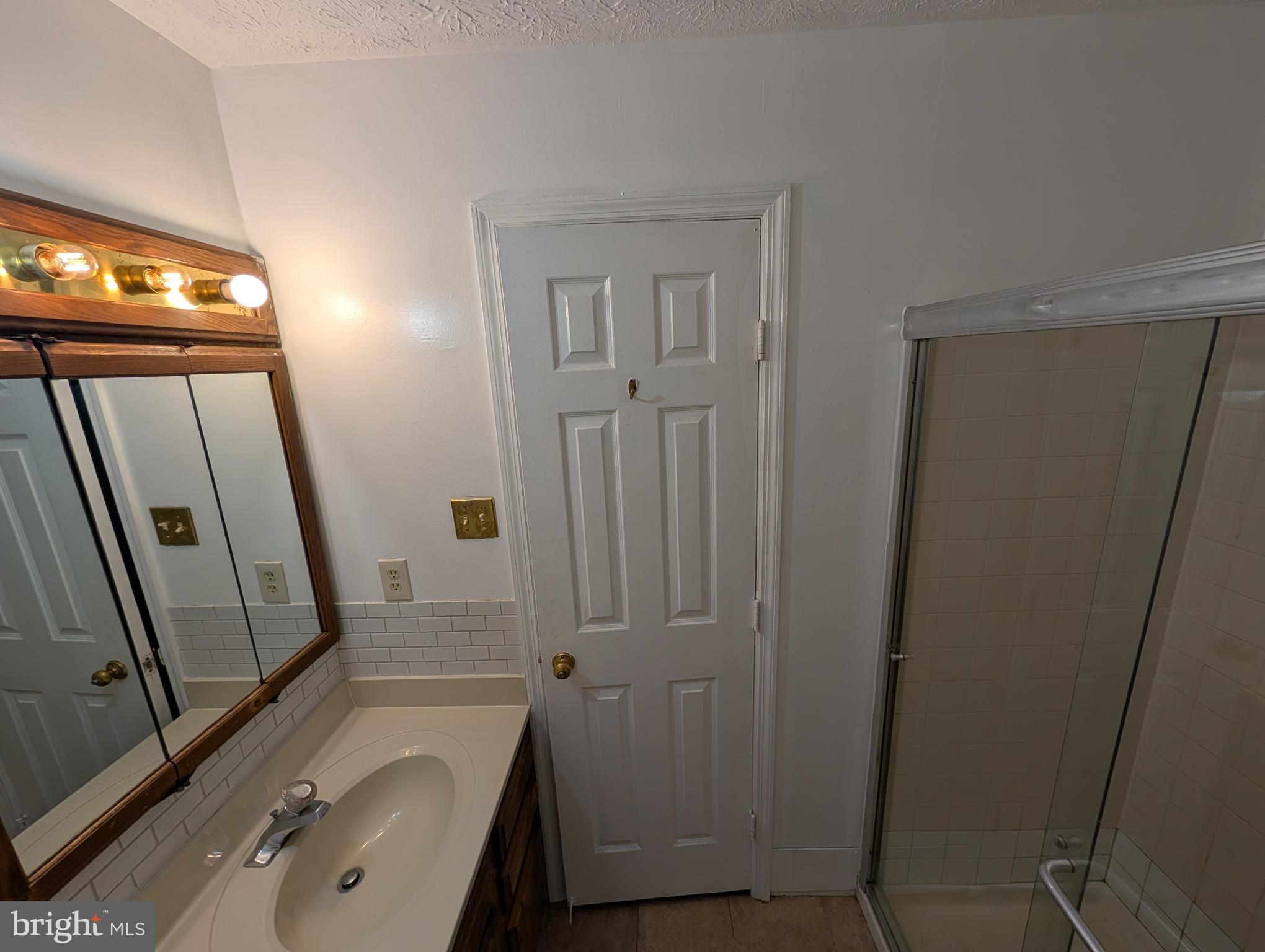 1301 L Cedar Crest Court, Unit 1301L Edgewood, MD 21040 - Photo 42 of 43 a bathroom with a granite countertop sink toilet and shower a mirror