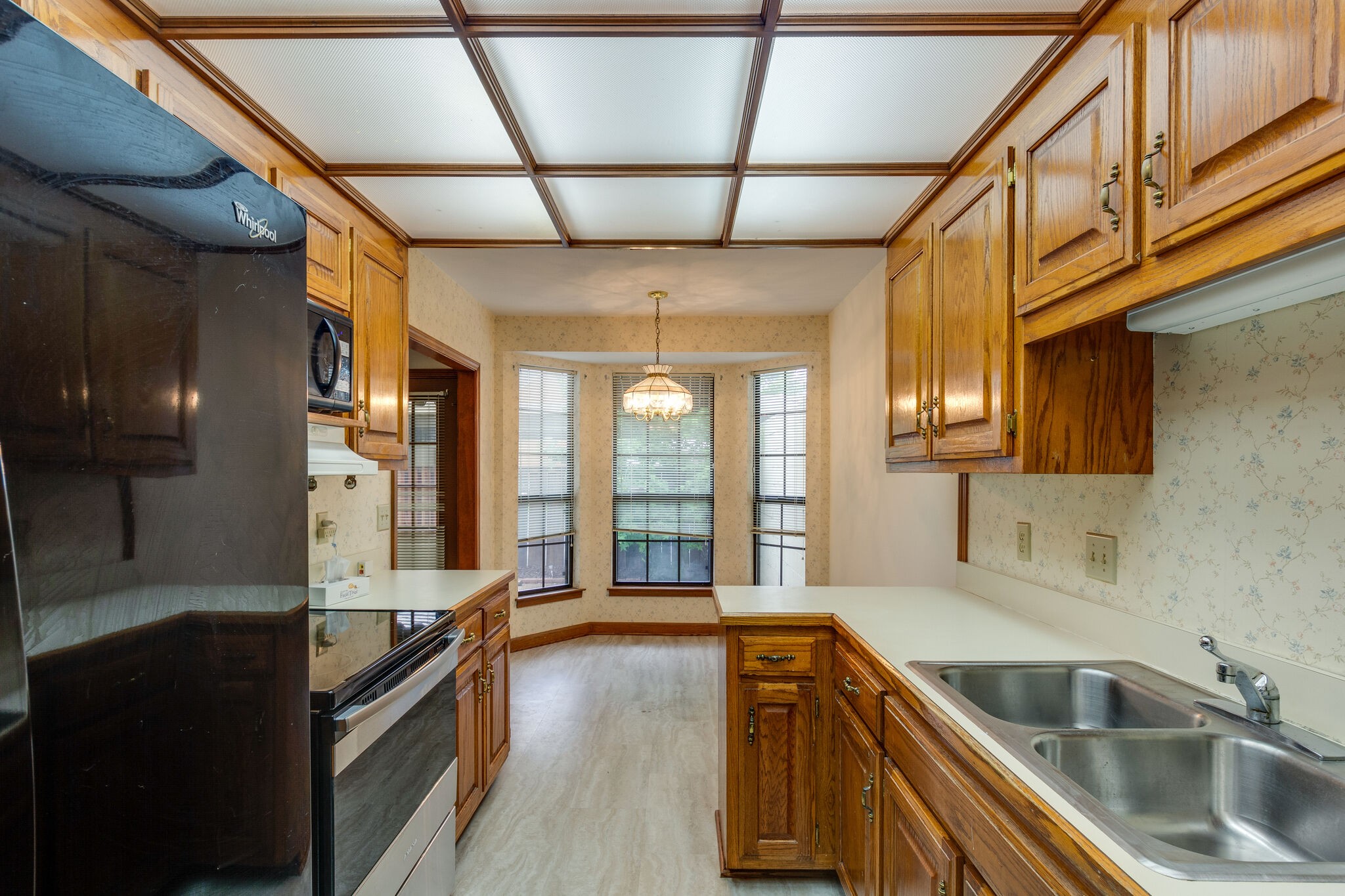 712 General George Patton Road Nashville, TN 37221 - Photo 11 of 35 a view of a kitchen with a sink and wooden cabinets
