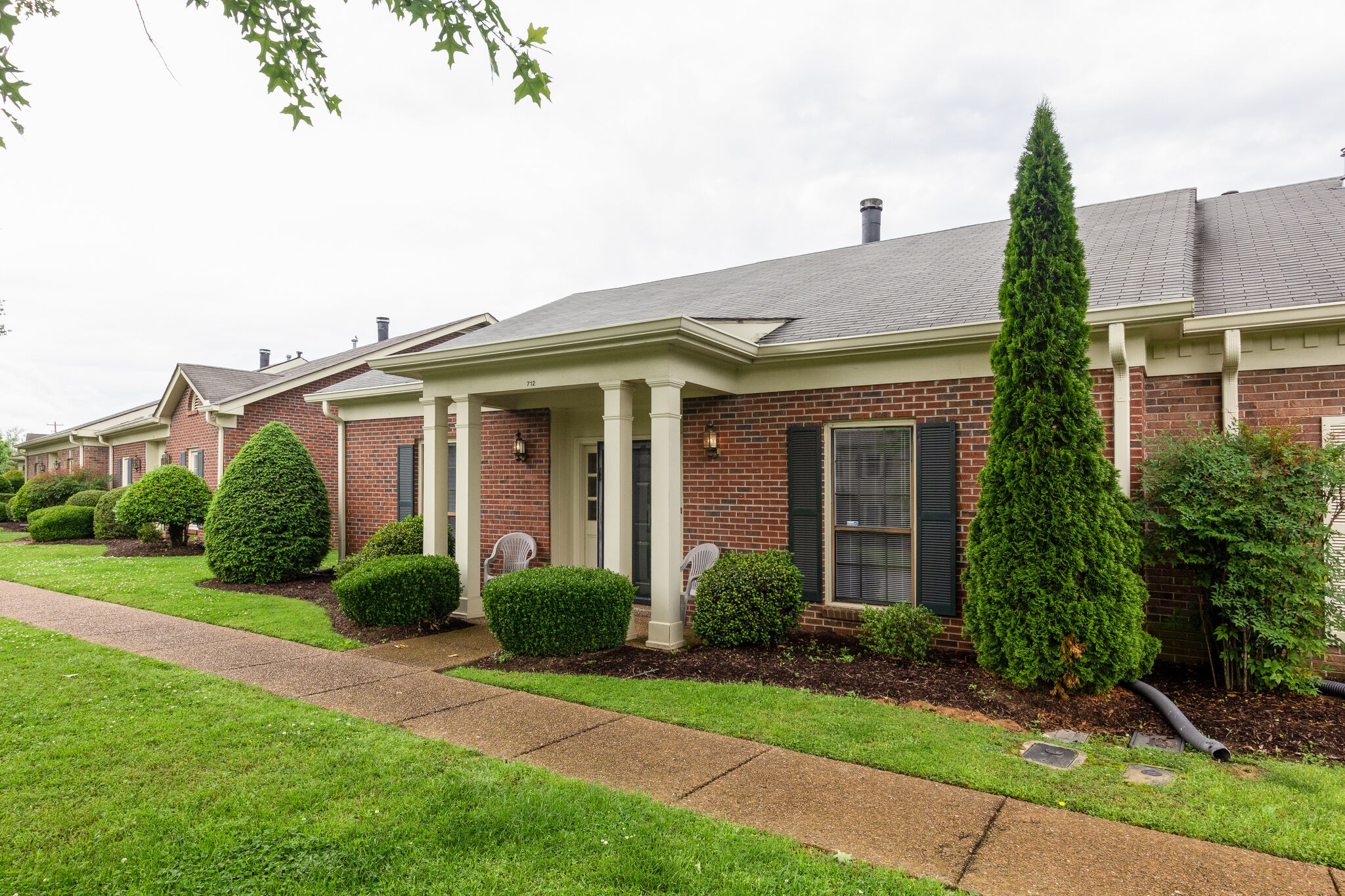712 General George Patton Road Nashville, TN 37221 - Photo 3 of 35 a view of a white house next to a yard with potted plants