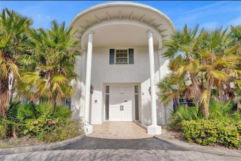 6750 Northeast 21st Road, Unit 123 Fort Lauderdale, FL 33308 - Photo 1 of 12 a front view of a house with a garden